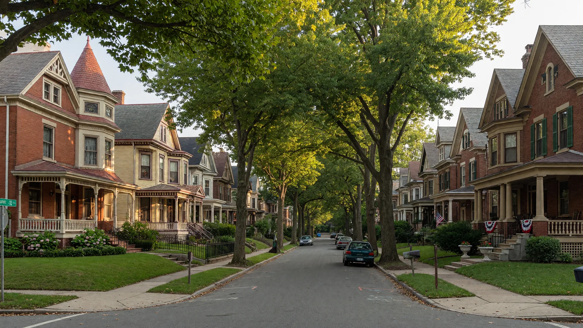 Tree-lined residential street in Lansdowne, Pennsylvania with Victorian and Queen Anne homes under warm late-summer morning light