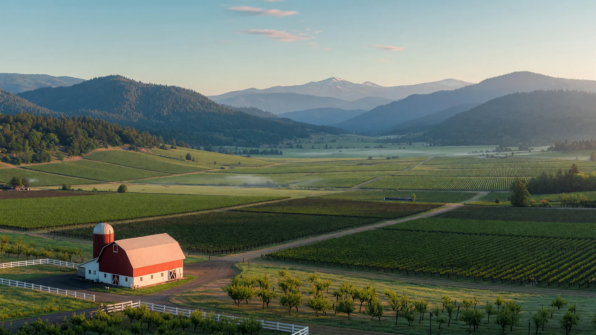 Morning light across the Rogue Valley, orchards and vineyards below the blue foothills