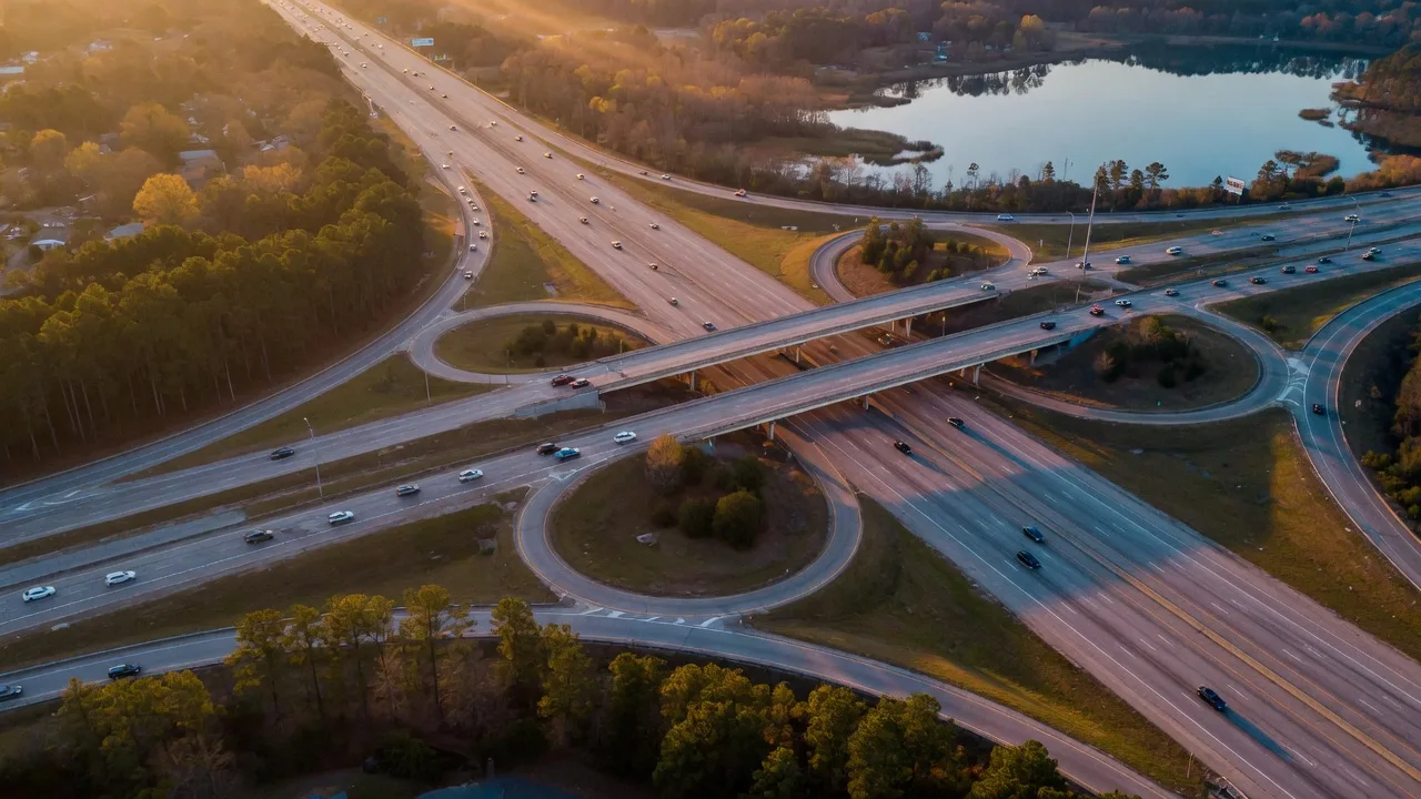 Aerial view of an interstate interchange in the Columbia SC Midlands at golden hour with morning commute traffic