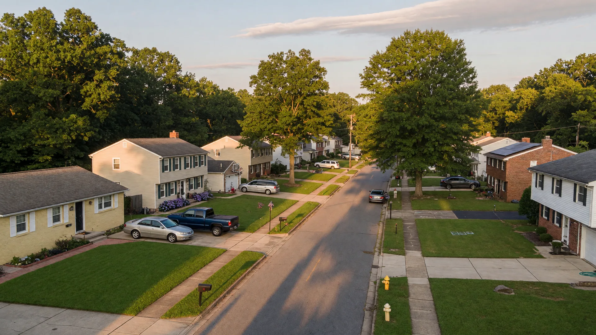 A quiet residential street of single-family homes in Prince George's County Maryland in warm afternoon light