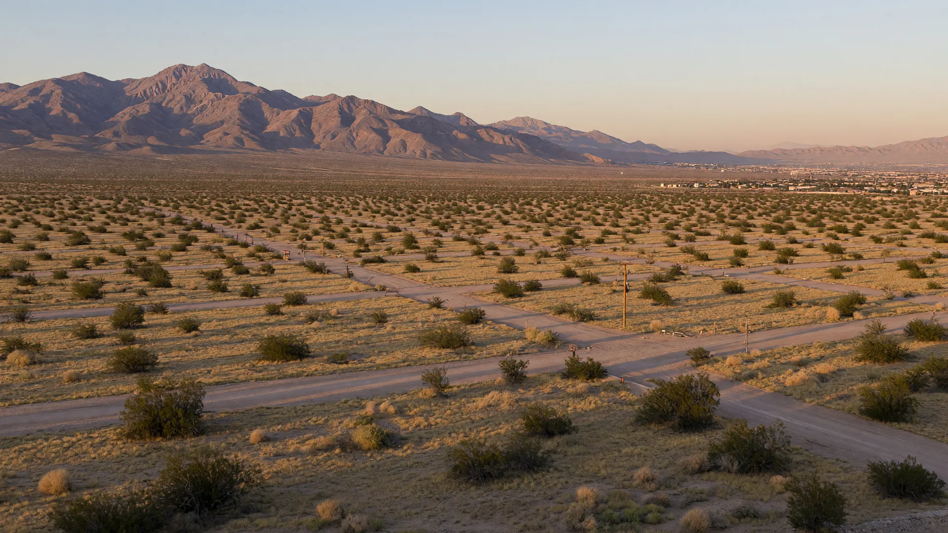 Undeveloped desert land at the northwest edge of the Las Vegas valley with graded home sites and the Spring Mountains on the horizon