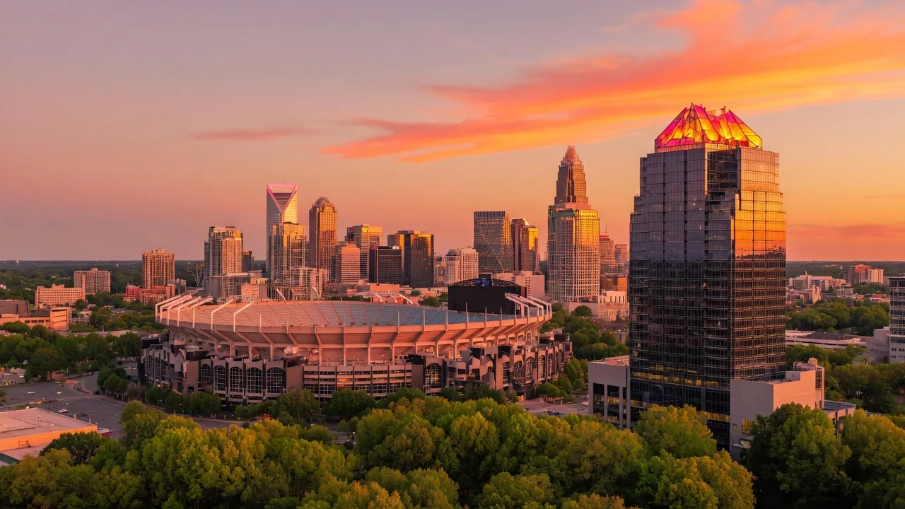 Charlotte North Carolina skyline at golden hour with Bank of America Stadium and Duke Energy Center