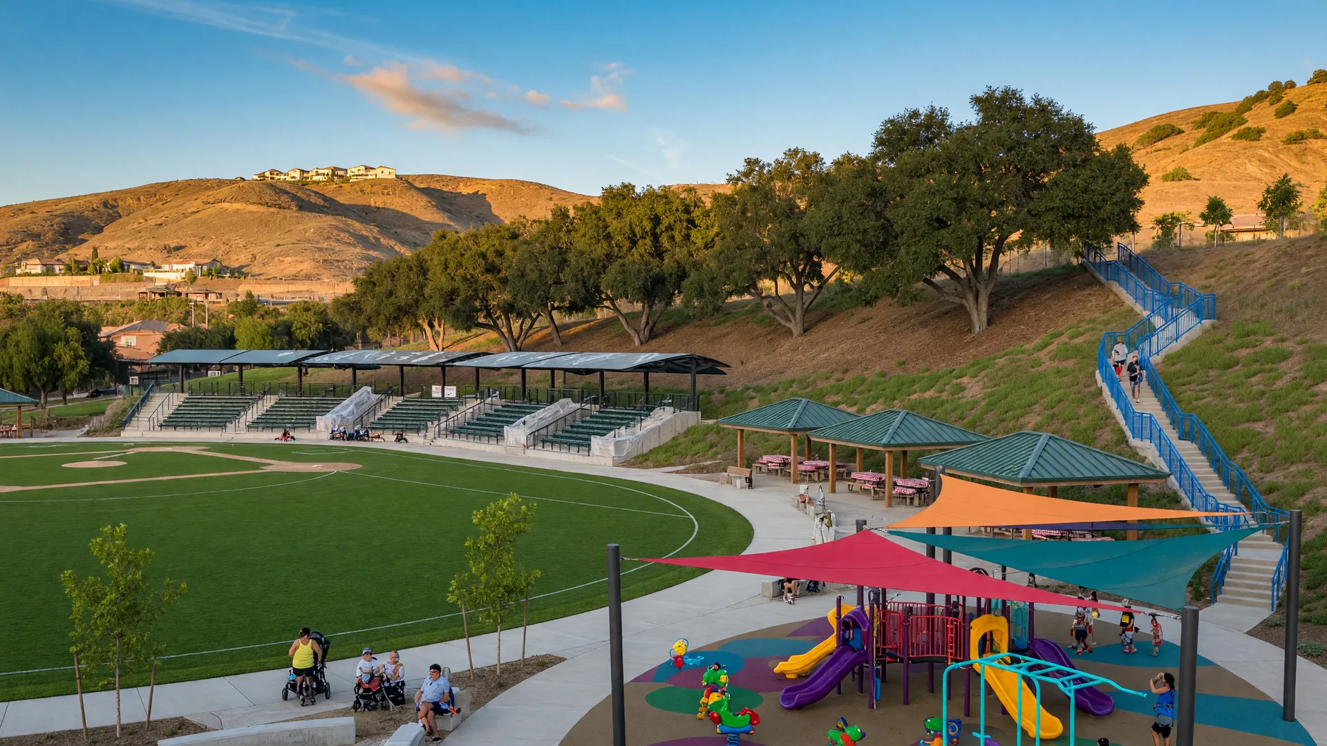 An expanded community park in the Santa Clarita Valley hills with a baseball field, shaded playground and walking paths