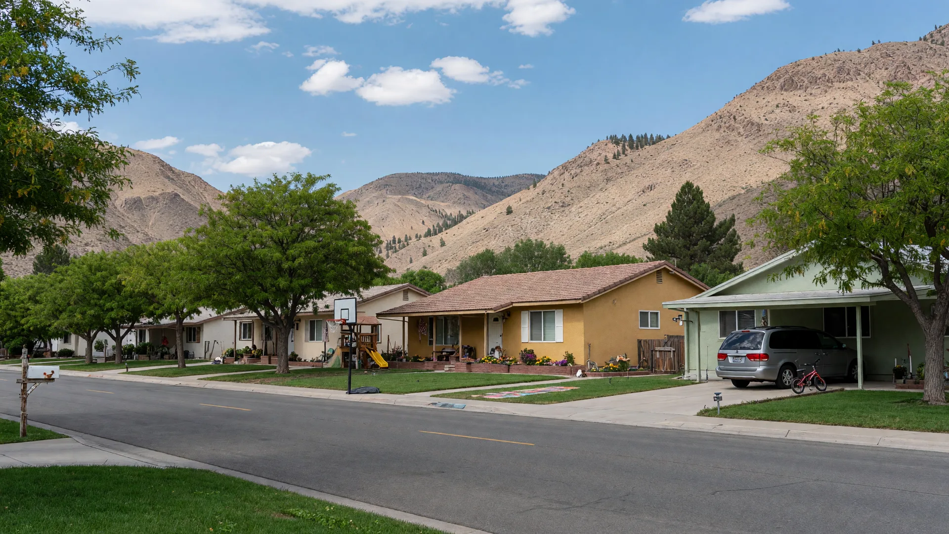 Quiet family-friendly street in a high desert community with mountain views
