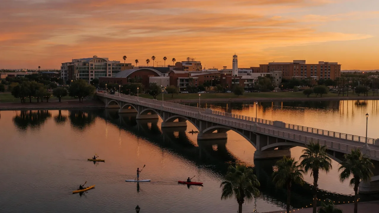 Tempe Town Lake at sunset with the Mill Avenue bridge, kayakers, and the ASU skyline behind