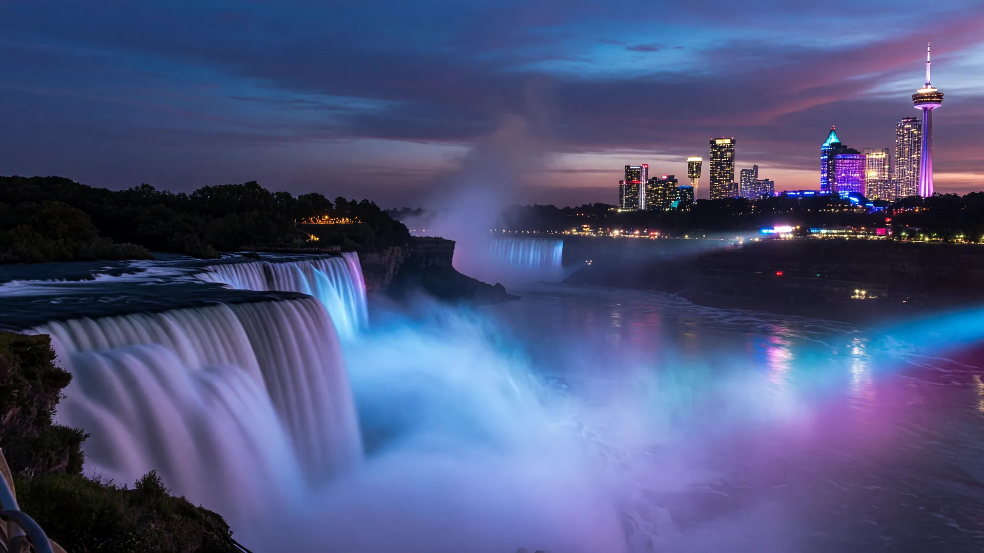 Niagara Falls at twilight with mist and illuminated skyline, representing the future of AI in real estate
