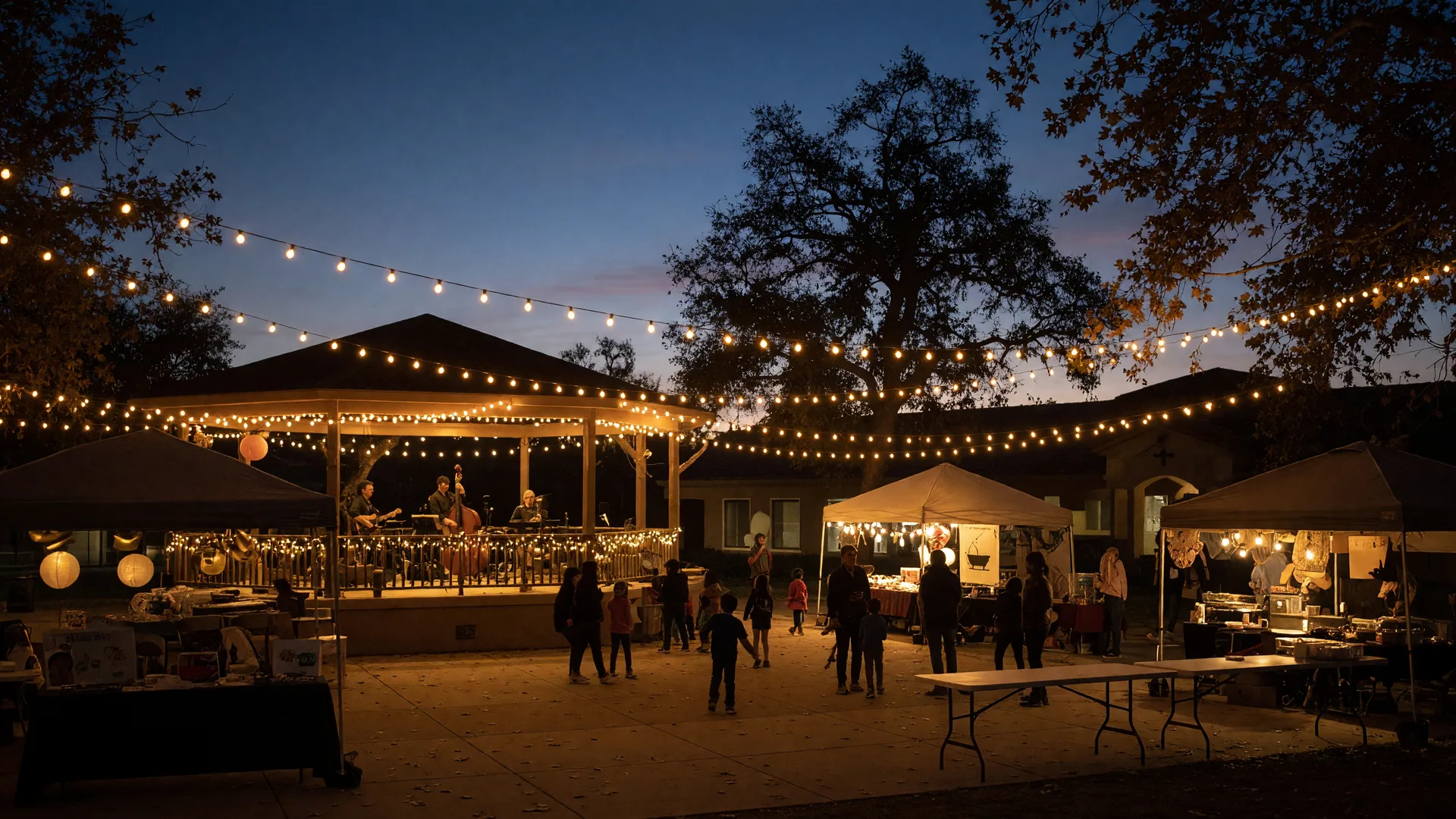A warm September community evening in the Santa Clarita Valley with string lights, a bandstand, and vendor tents