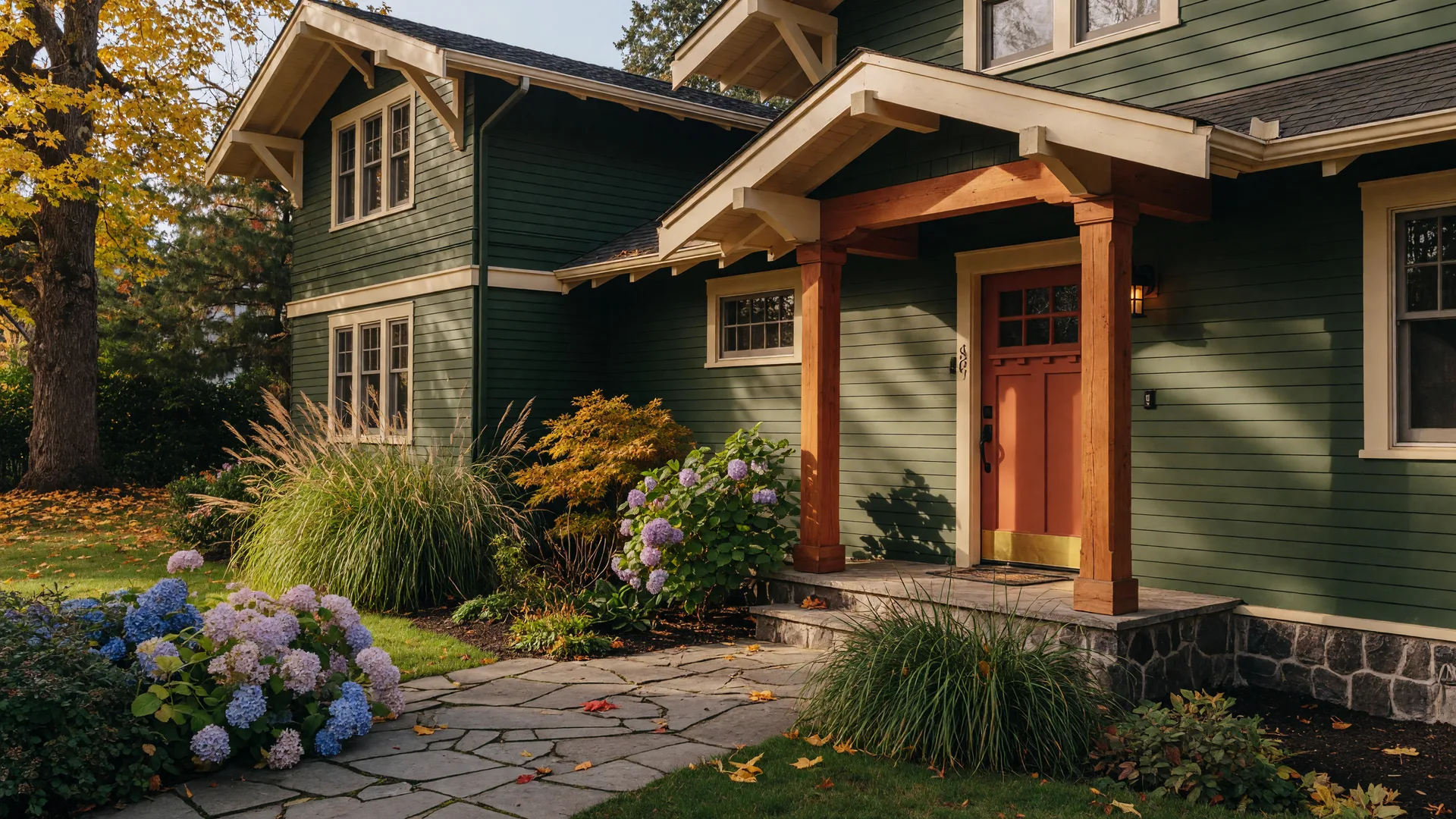 Craftsman-style Portland home with forest green siding, a terracotta front door, and a covered porch, representative of the listing at 7642 SE Harrison St