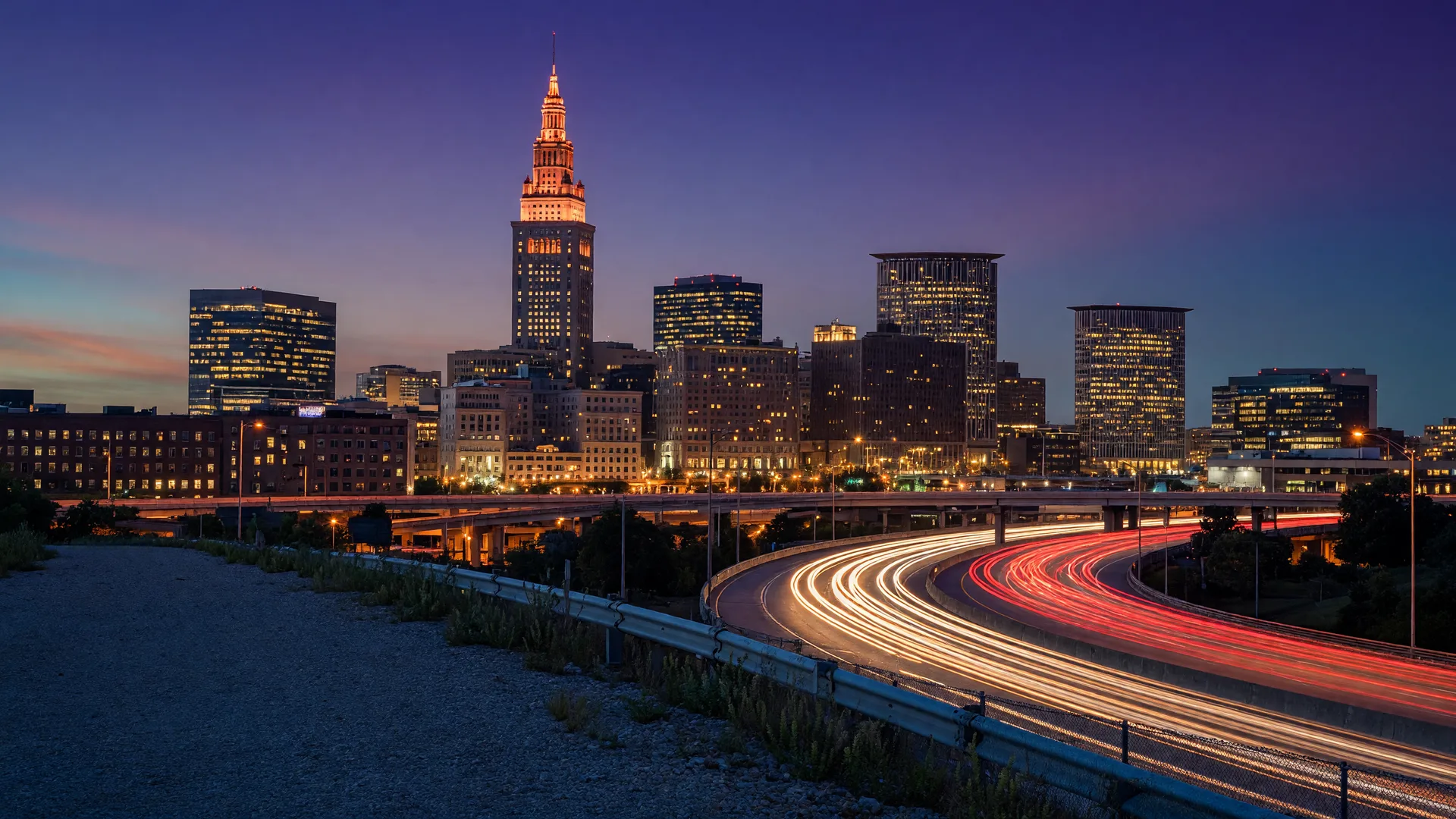 Cleveland skyline at dusk with car light trails on the interstate