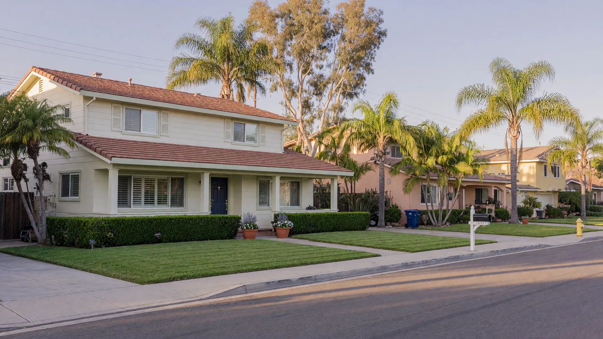 A well-maintained residential home on a quiet sunny San Diego street, representing compliant recovery housing