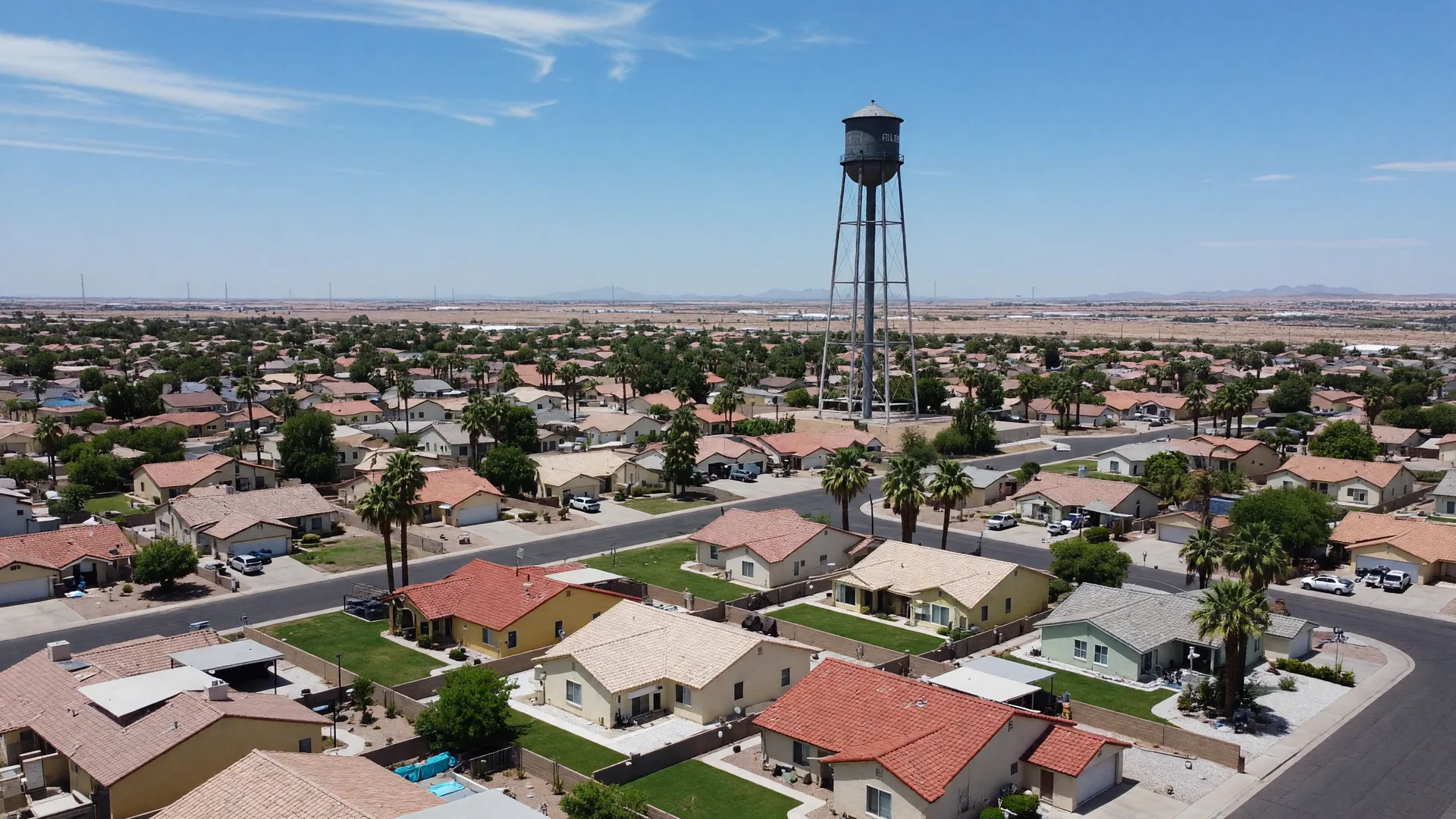 Golden hour view of Gilbert, Arizona, with the historic water tower above tree-lined family neighborhoods