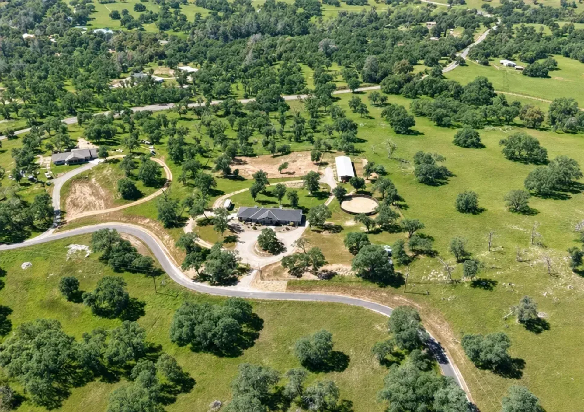 Aerial view of a ranch property on rolling hills in Catheys Valley, California