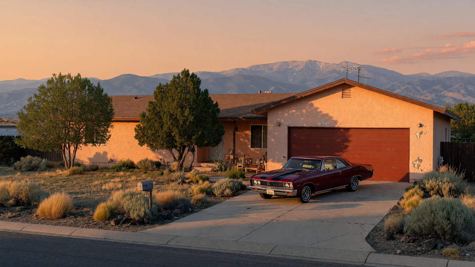 Dayton, Nevada home at 133 Denio with a deep garage and a classic car in the driveway, Sierra Nevada range at golden hour