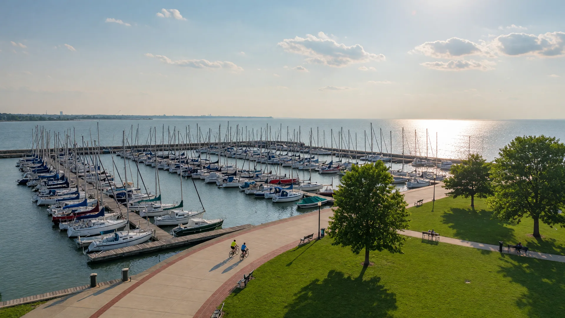 Sailboats at a Lake Erie marina with a lakefront park in Mentor Ohio on a bright morning