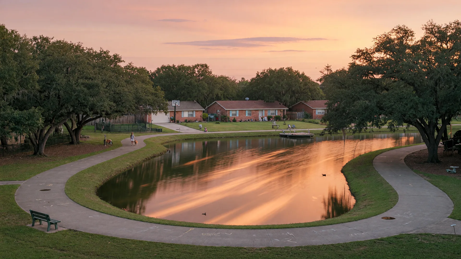 Golden-hour view across a Texas community pond with a walking path, illustrative of the pond-side loops in Morton Ranch, Katy