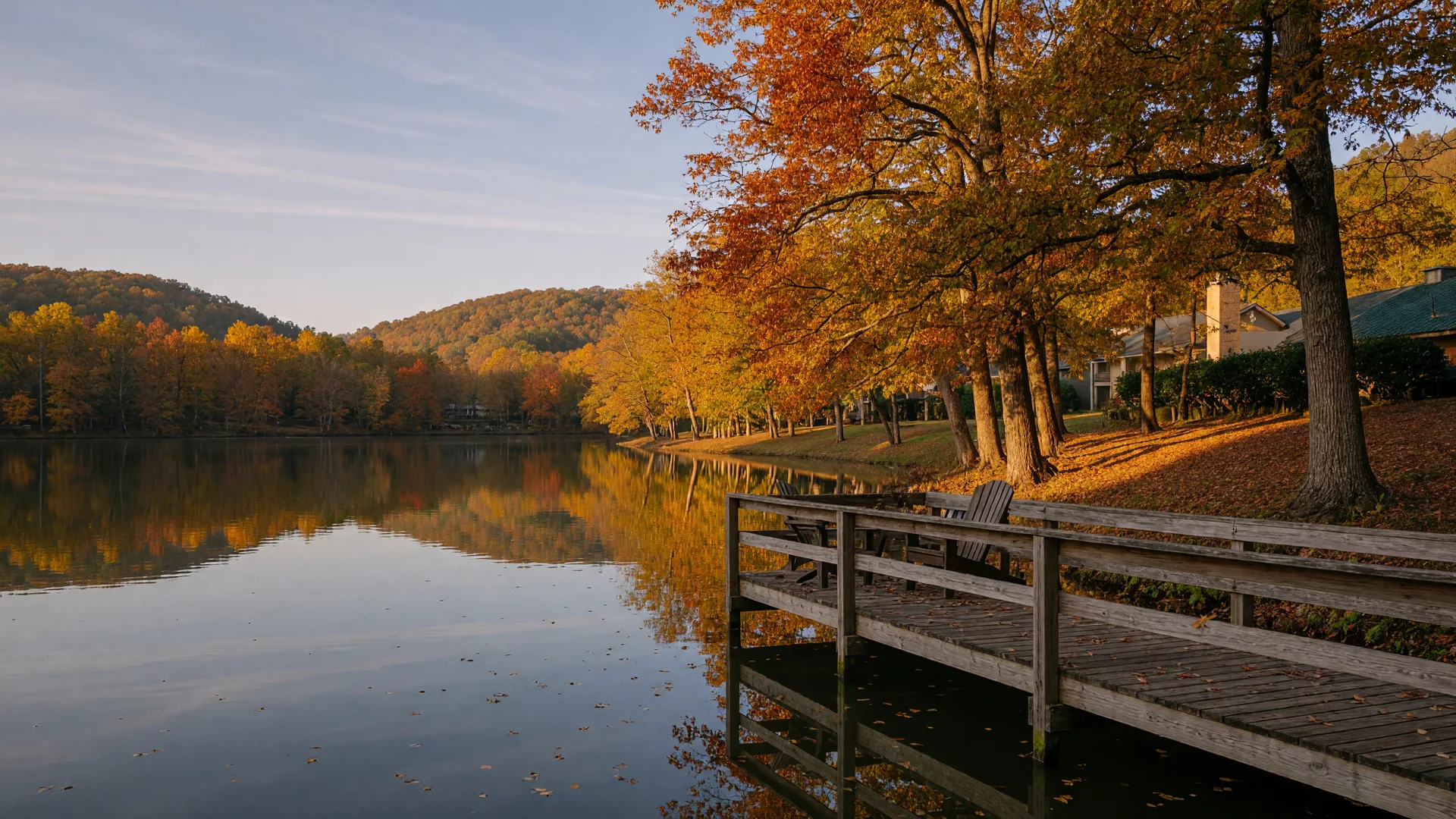 Peaceful autumn lake scene in Northwest Georgia with fall foliage, a wooden dock, and calm water reflecting golden-hour light