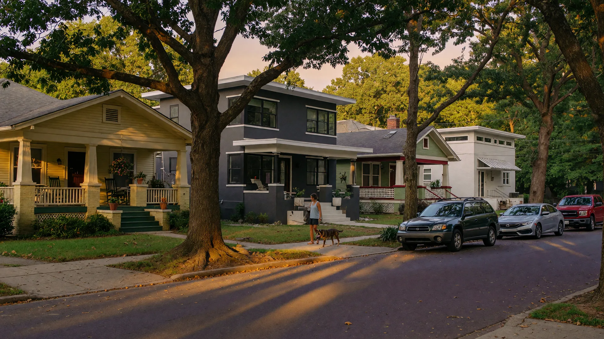 Tree-lined street in Villa Heights Charlotte NC with historic Craftsman bungalows and modern infill homes under warm afternoon sunlight