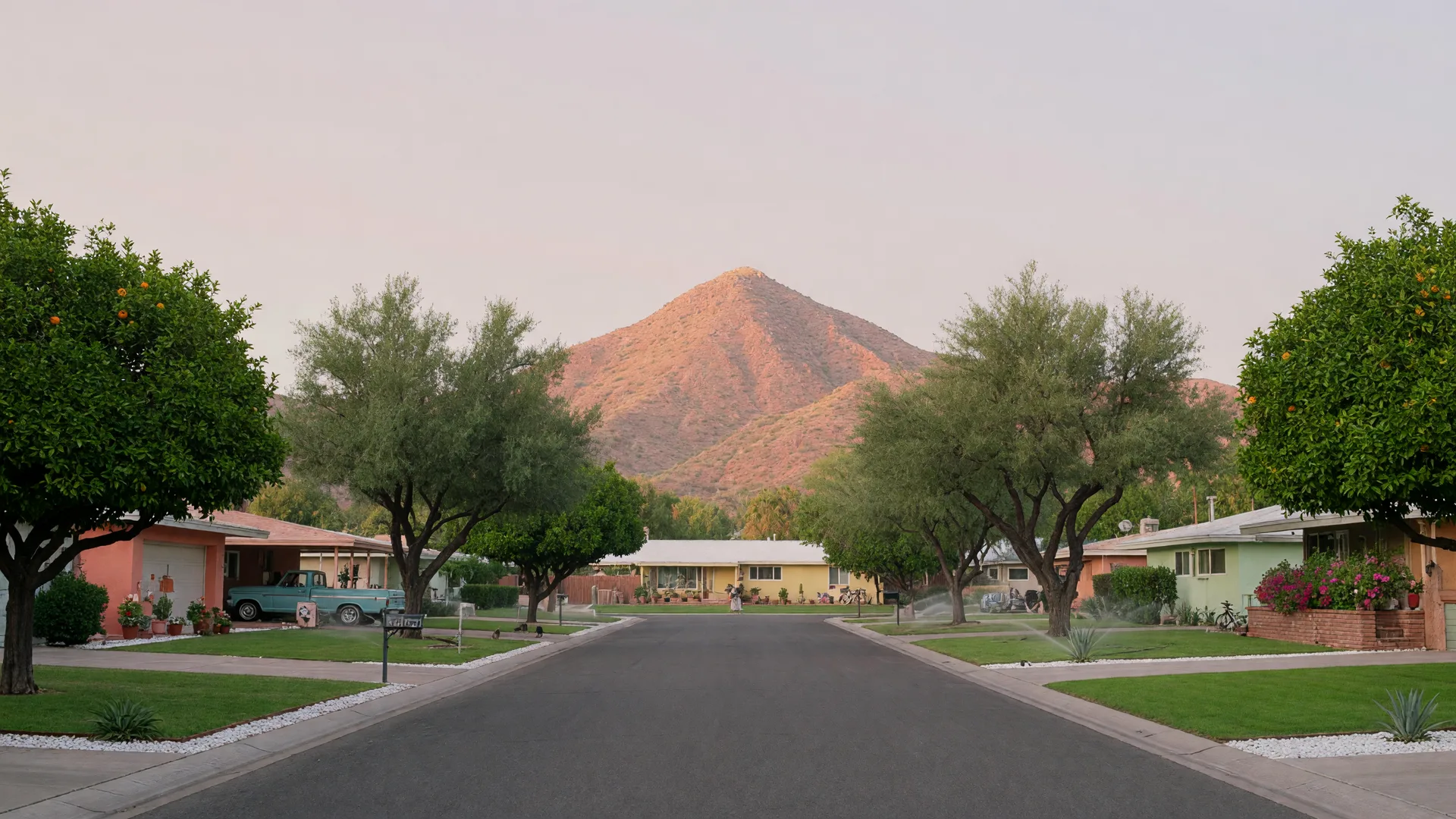Leafy Arcadia street with mid-century ranch homes and Camelback Mountain at the end
