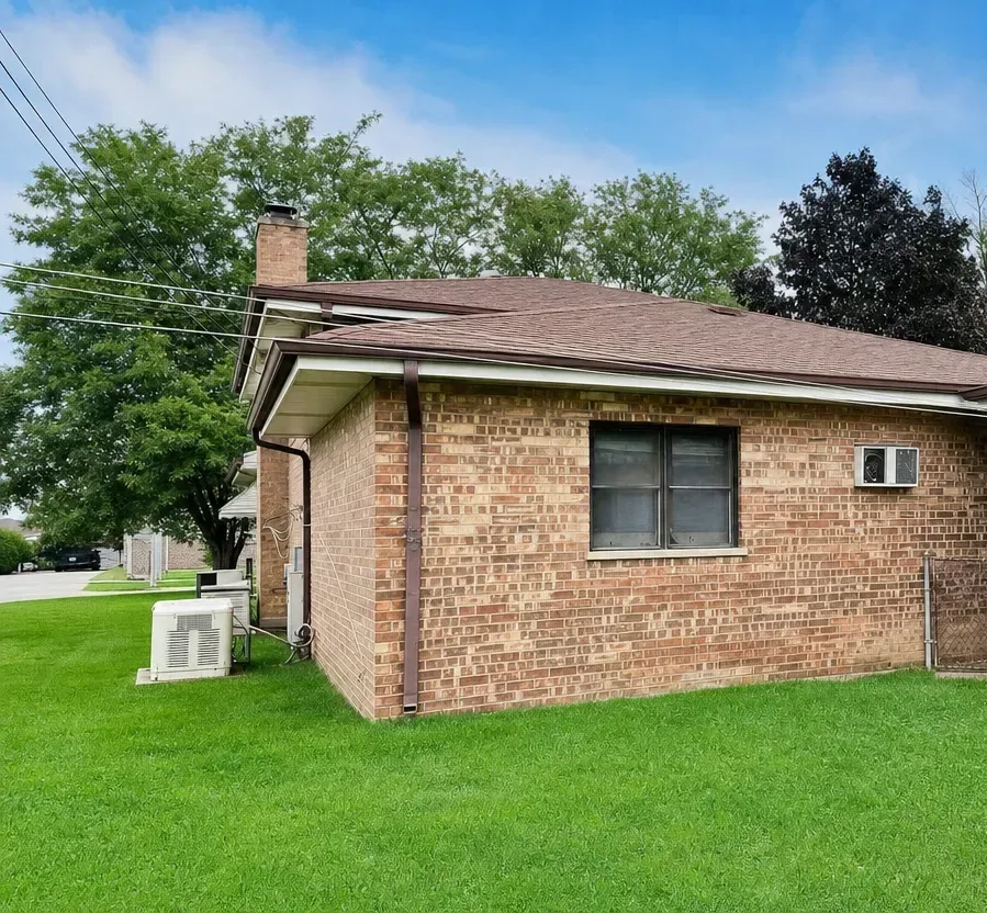 Backyard view showing exterior side with generator and AC unit