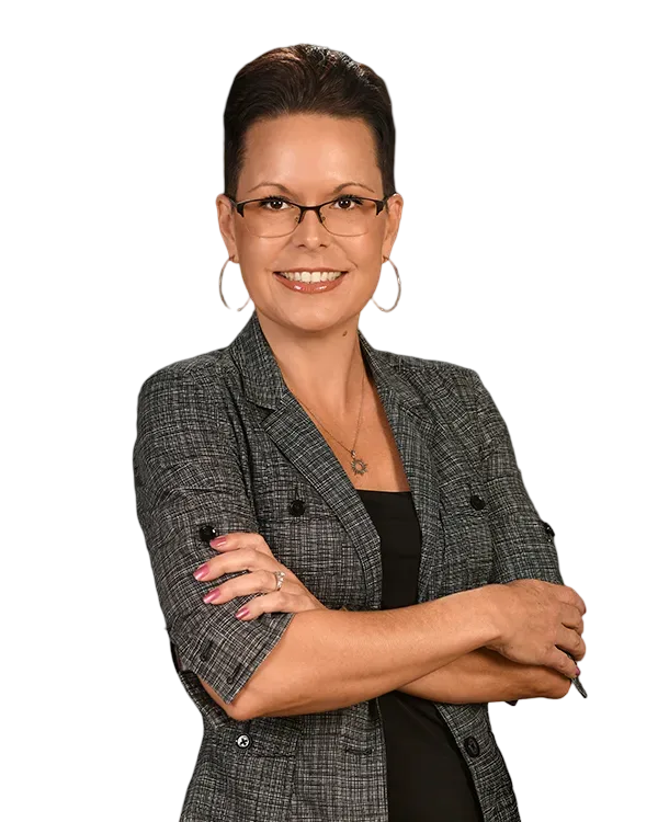 Mary Dover, Broker with Serenity Collective Real Estate, photographed with short dark hair, glasses, and a grey patterned blazer