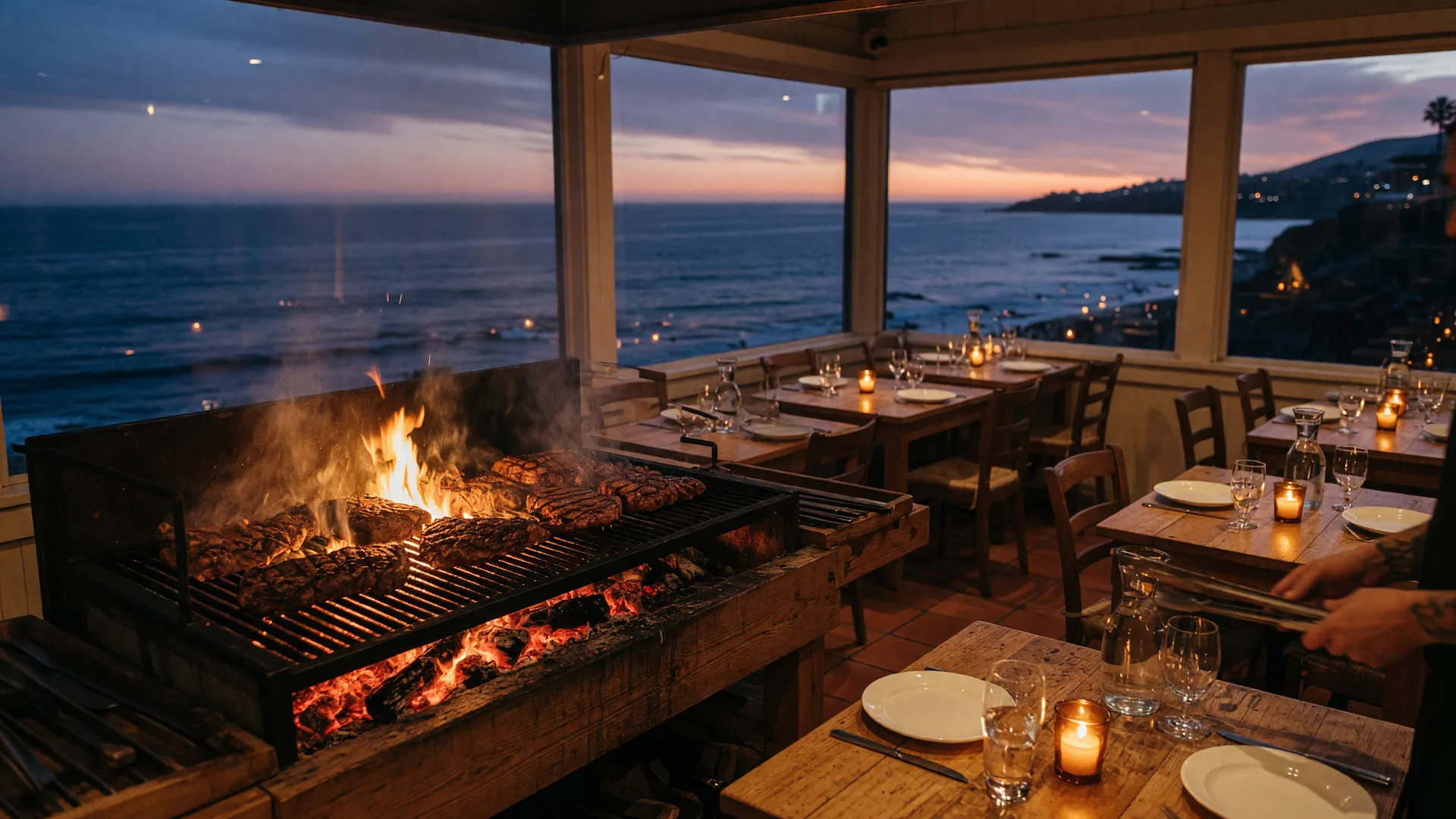 Coastal wood-fire grill steakhouse at dusk with embers and searing steaks over oak coals, candlelit rustic wooden tables, warm amber light