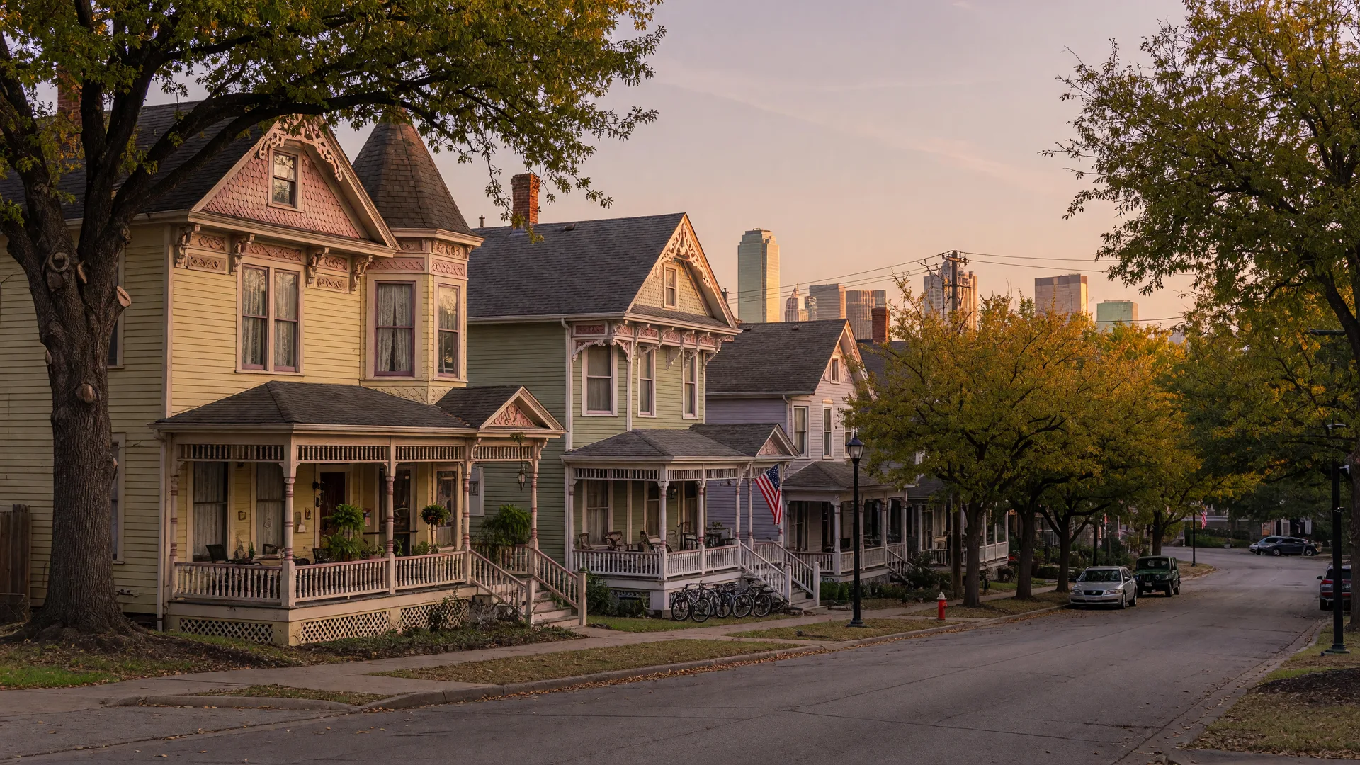 Preserved Victorian frame homes with wraparound porches on a tree-lined street in the State Thomas historic district of Uptown Dallas