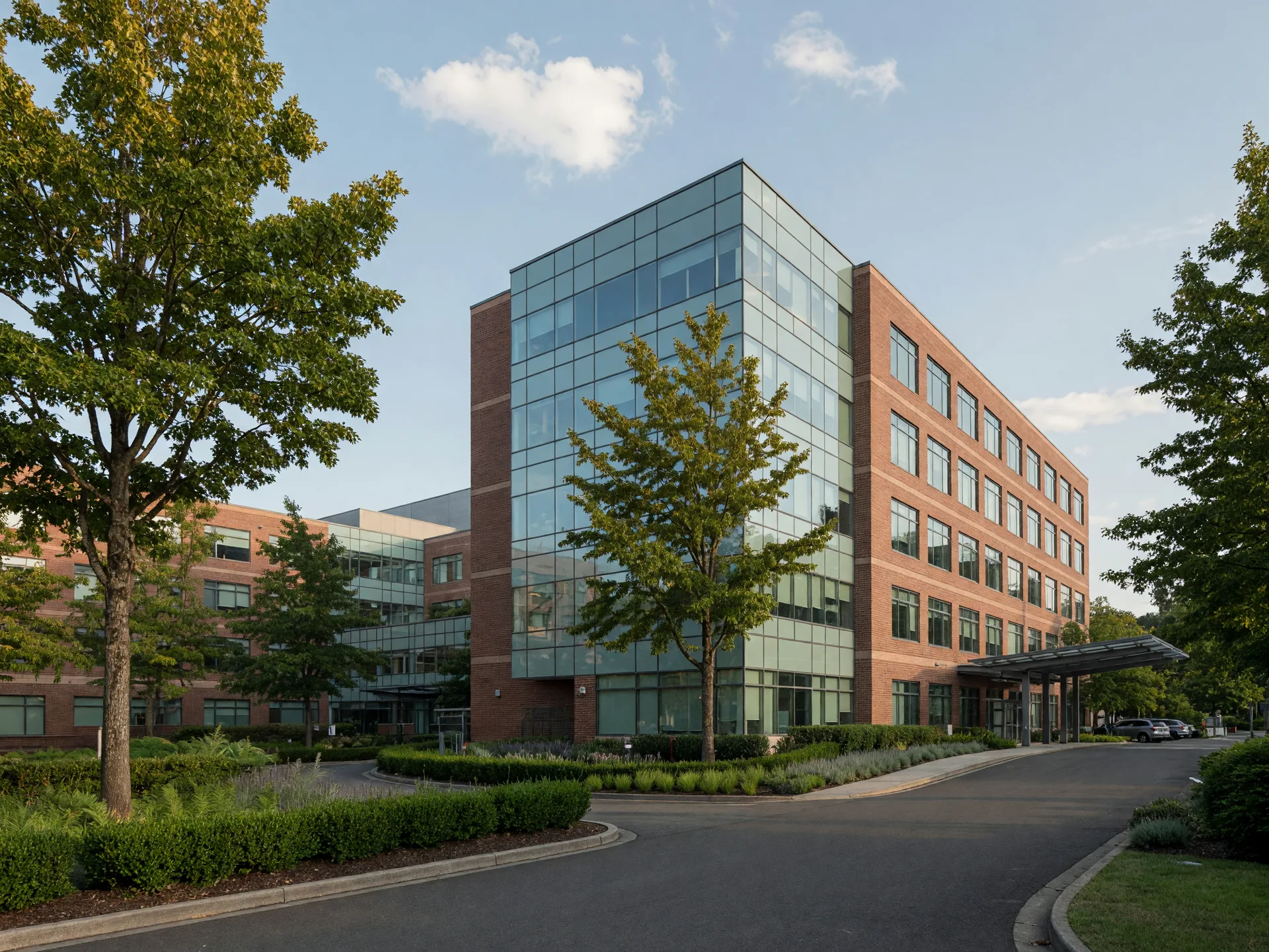 Modern glass and brick medical buildings on a Southeast Portland hospital campus among mature trees