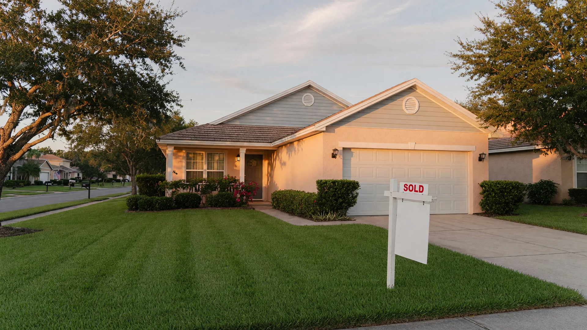 Central Florida home with a for sale sign in the front yard at golden hour