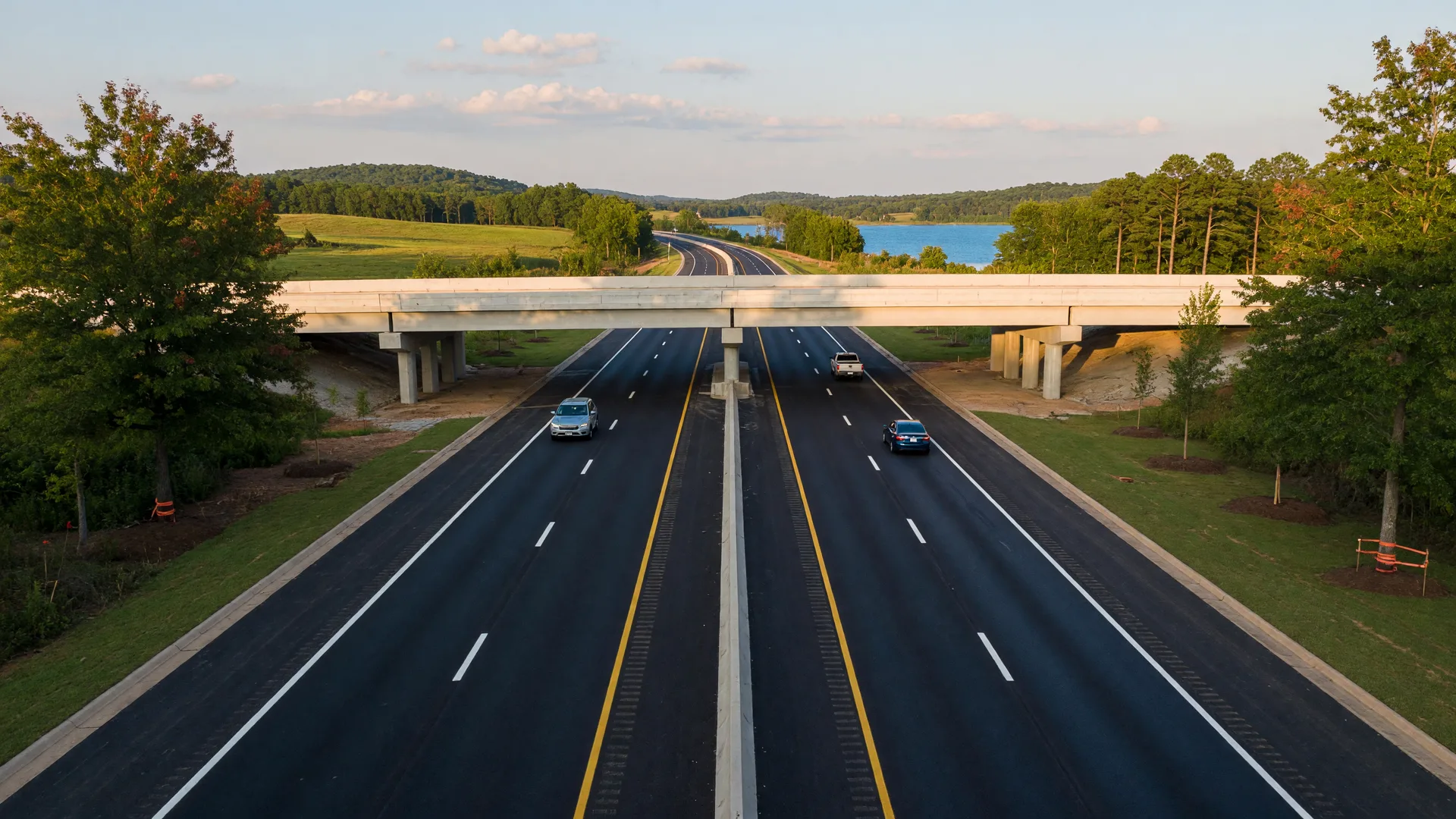 A major road construction project with new lanes being paved near Lake Norman