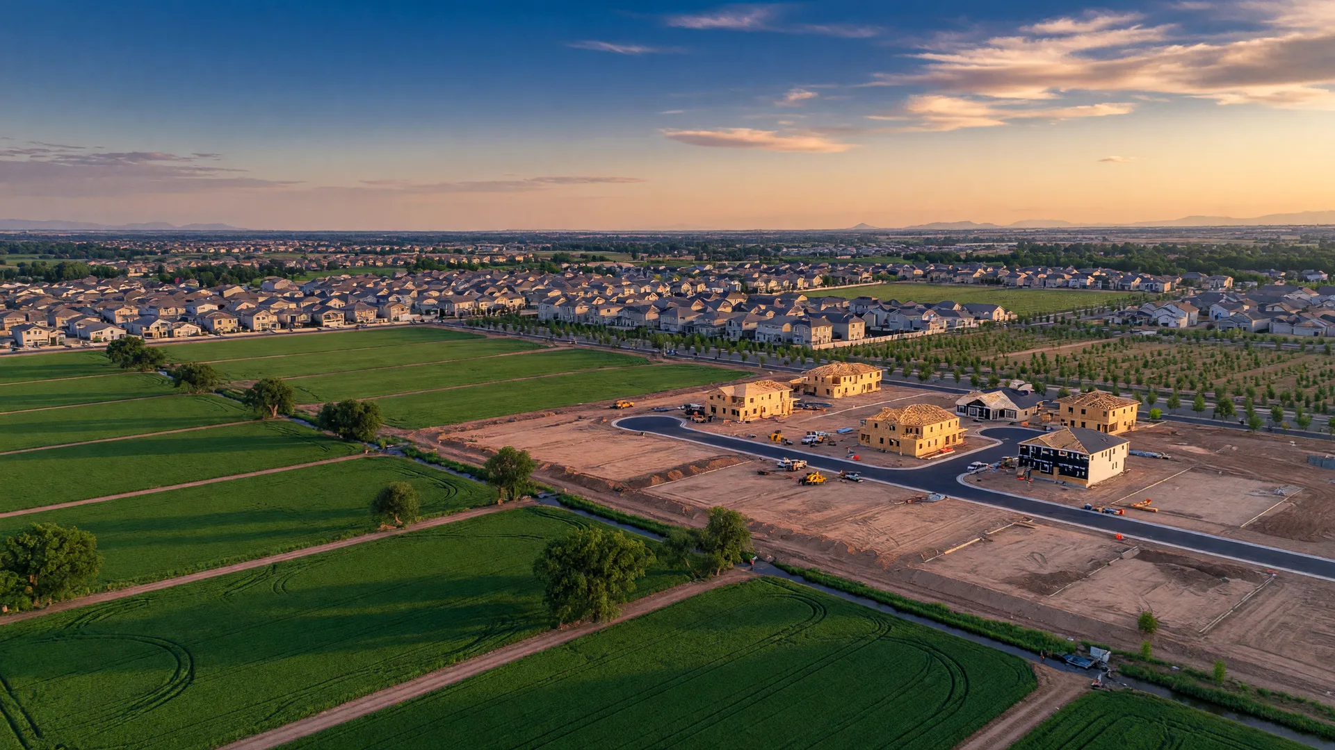 Aerial view of the Treasure Valley at golden hour showing a mix of farmland and new residential development