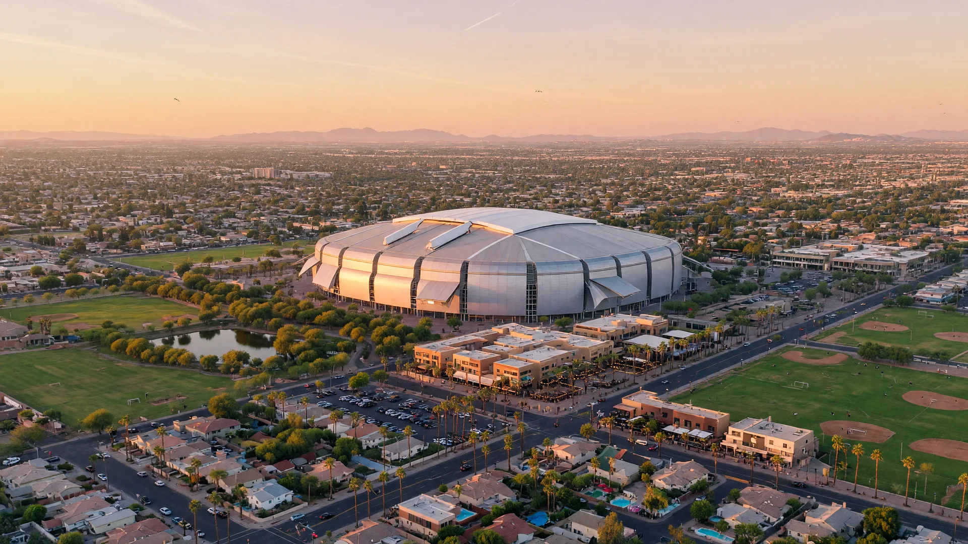 Golden hour aerial view of Glendale, Arizona,with State Farm Stadium and Westgate glowing among palm-lined neighborhoods