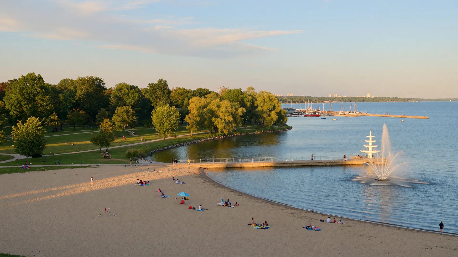 Sandy beach and green lakeshore park on Lake Ontario in south Oshawa at golden hour