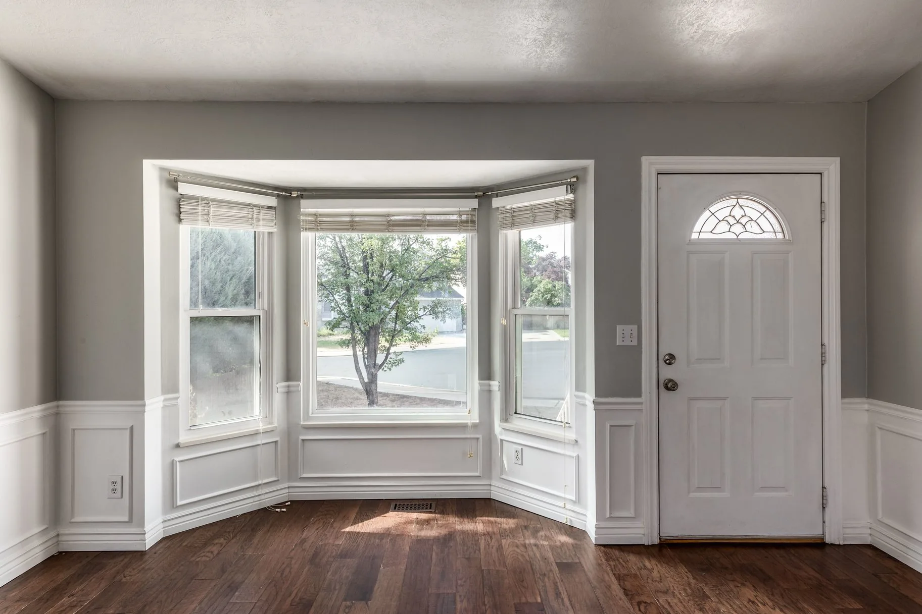 Entryway with bay window and hardwood flooring