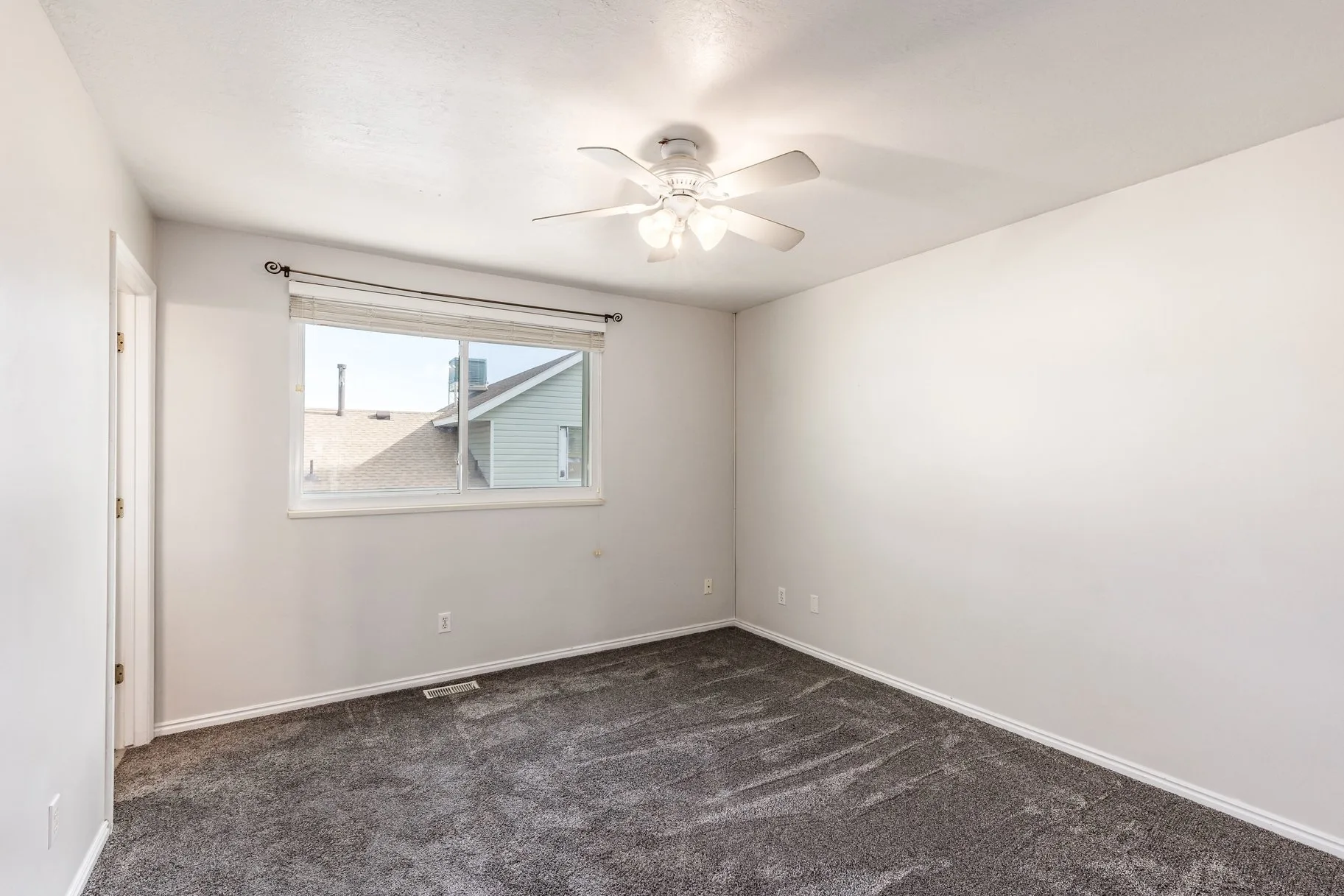 Bedroom with gray carpet and white walls