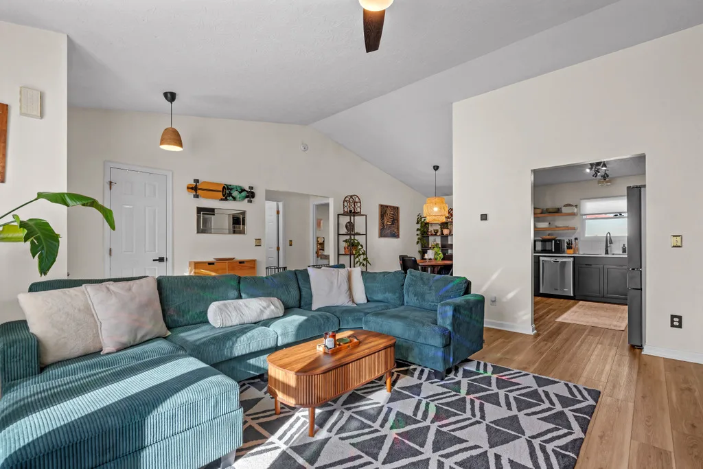 Vaulted living room open to the kitchen and dining area