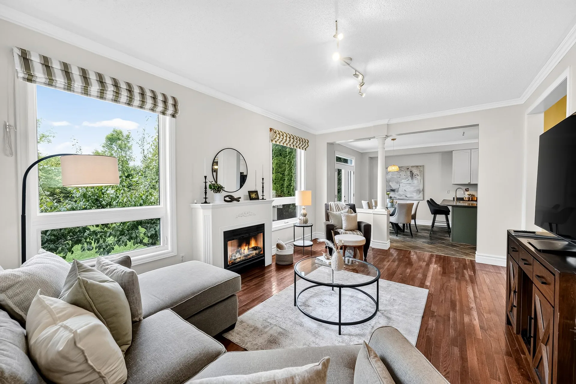 The family room at 459 Victoria with a gas fireplace, large windows and hardwood floors, the kind of bright main-floor space buyers compare first