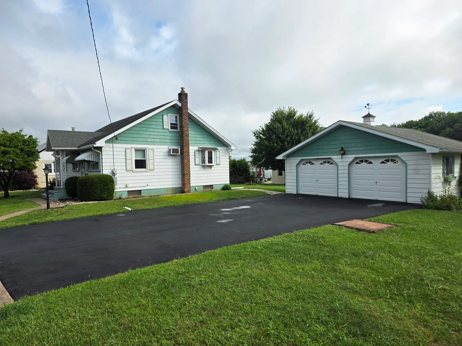 Exterior view of 4365 Spruce St showing the ranch-style home and detached two-car garage
