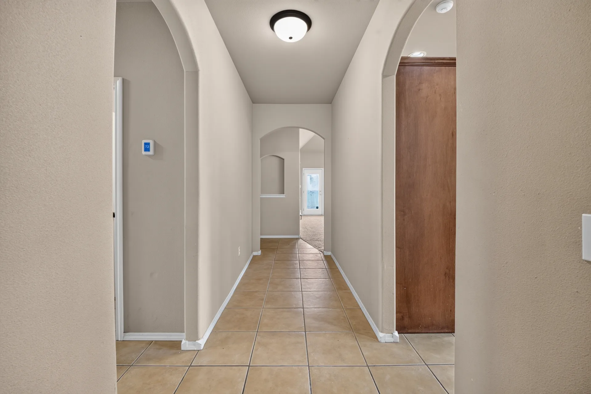 Hall with archways and tile floors