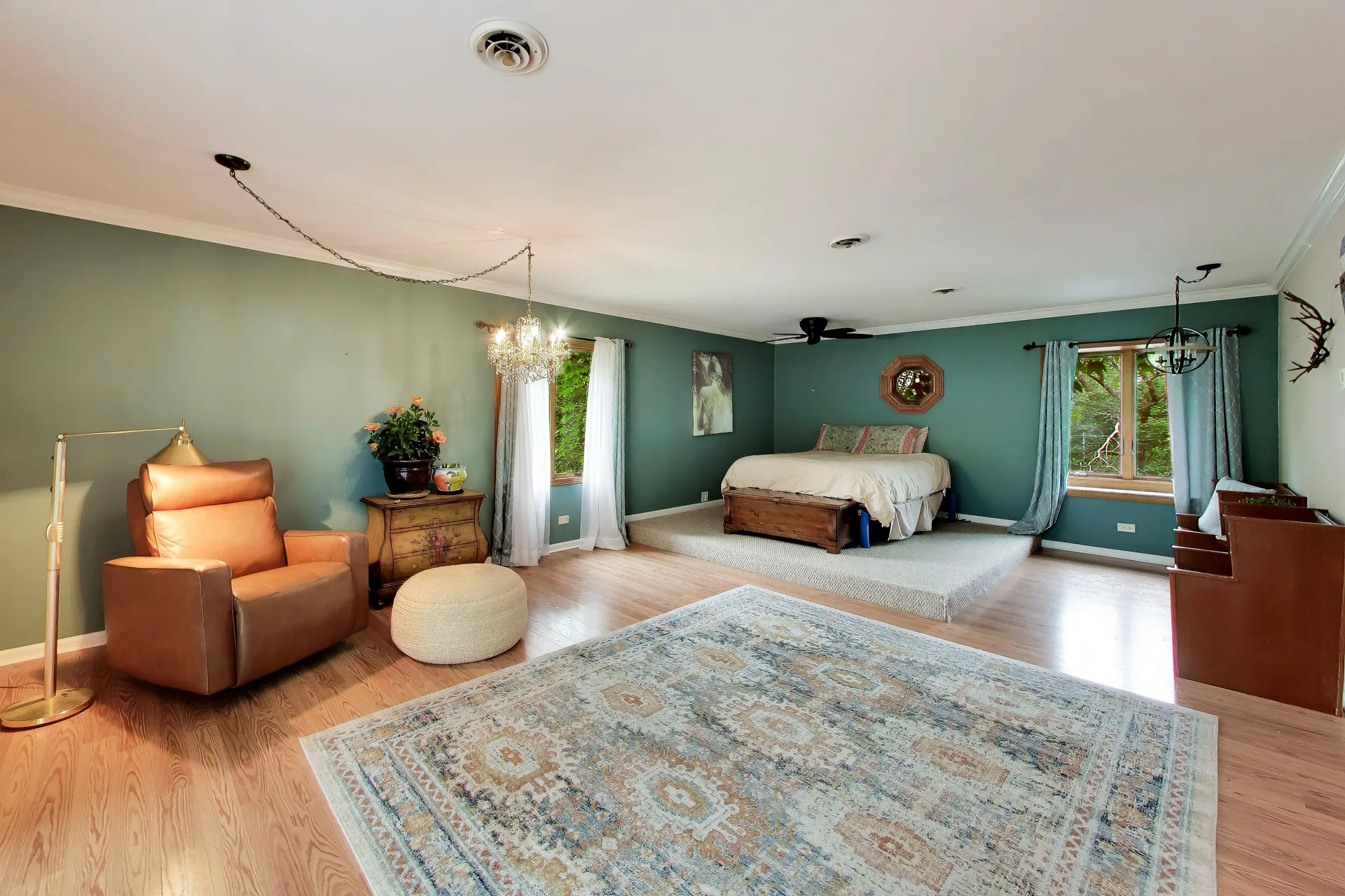 Primary bedroom with raised platform and green walls