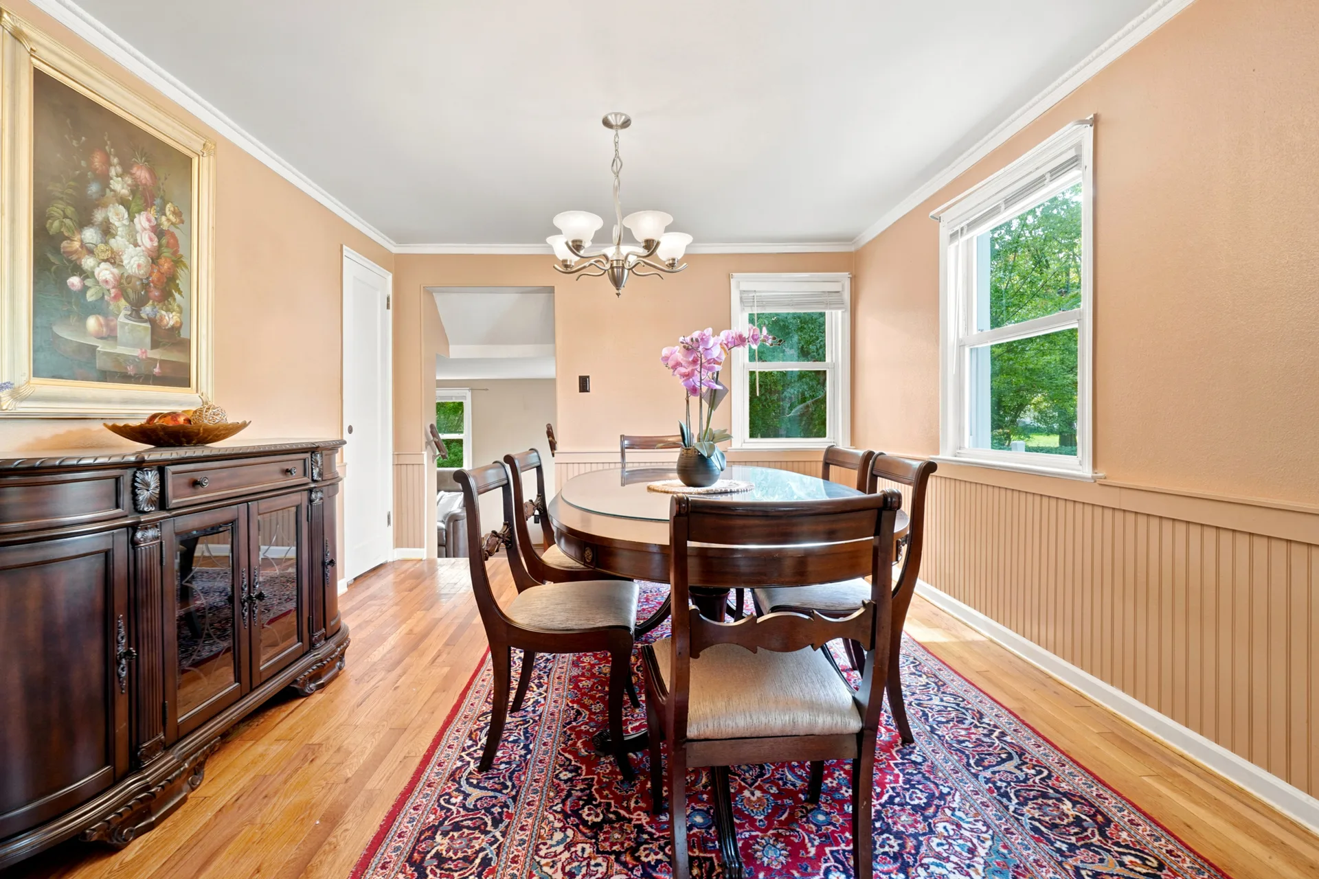 Formal dining room with wainscoting and warm paint tones