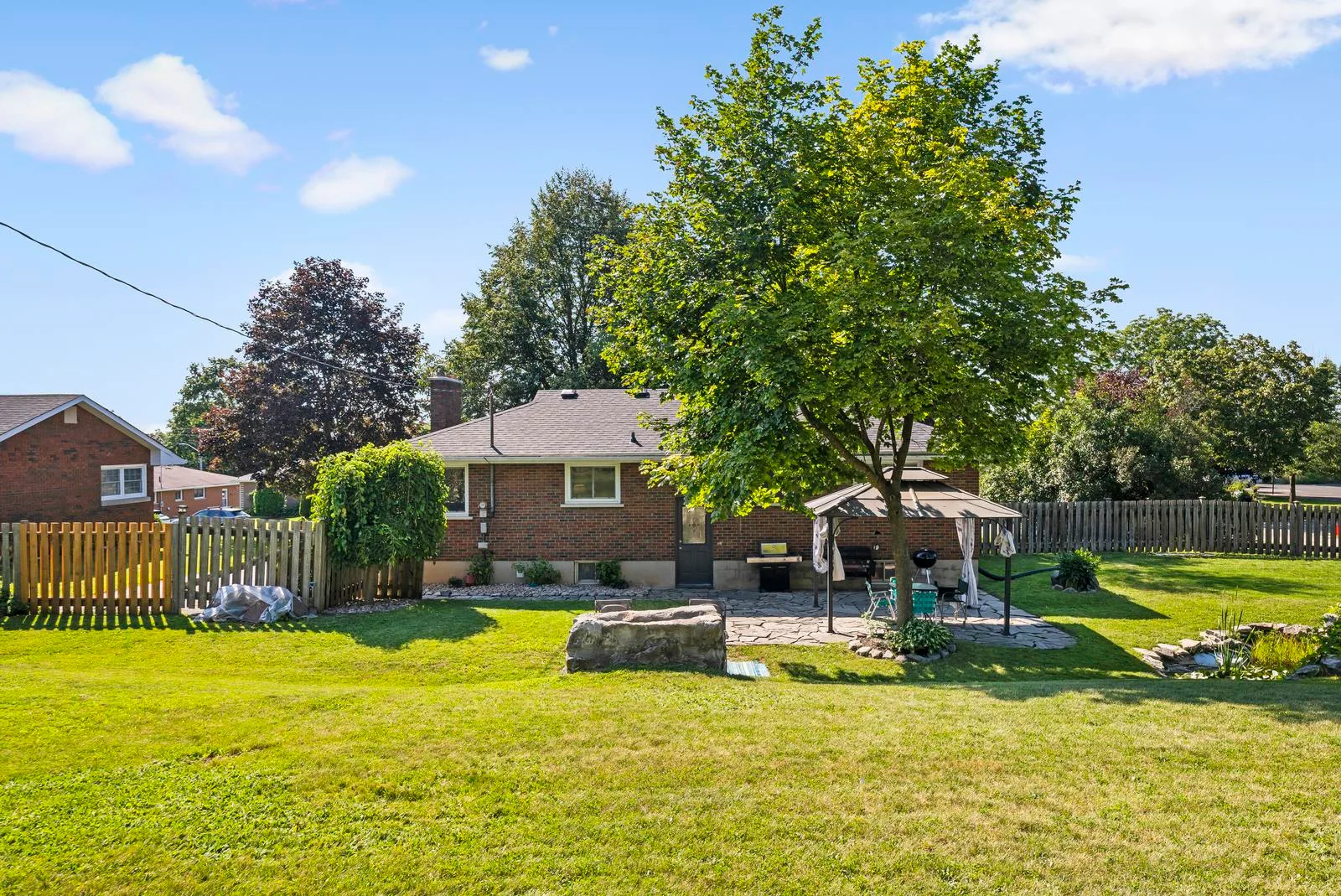 Backyard with flagstone patio, gazebo, and mature trees