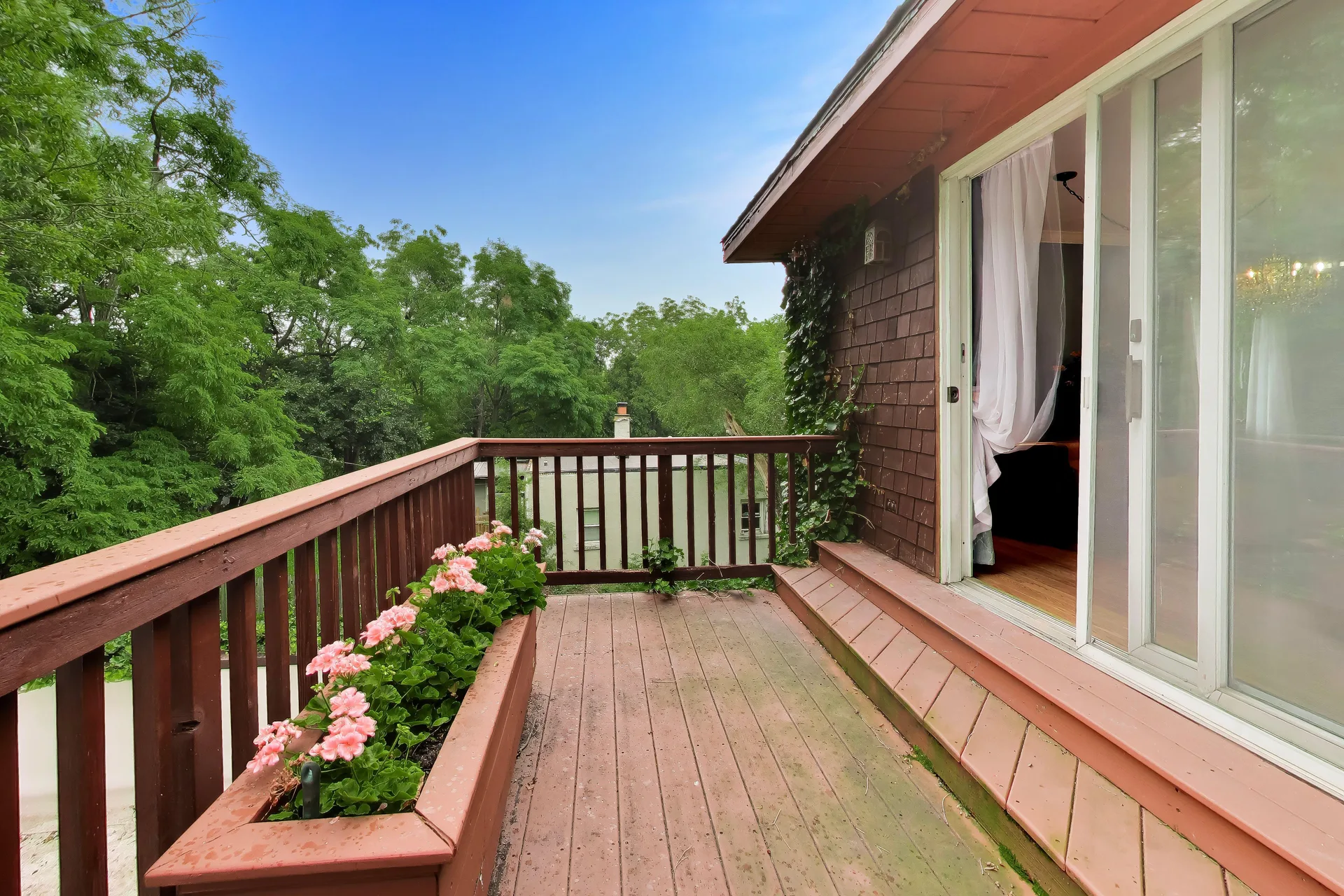 Elevated wood deck off the upper level with planter box