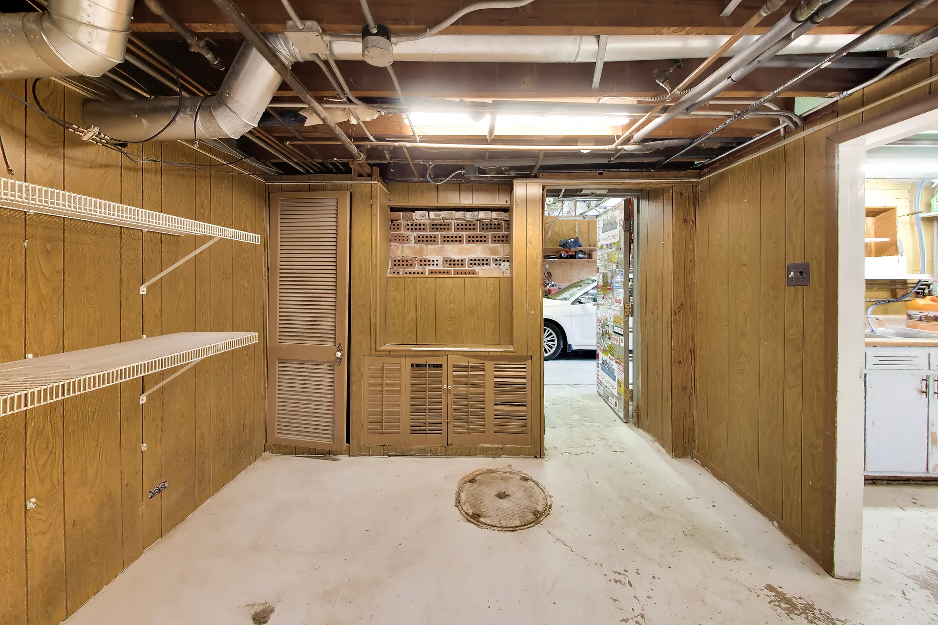 Unfinished basement storage with workshop wall