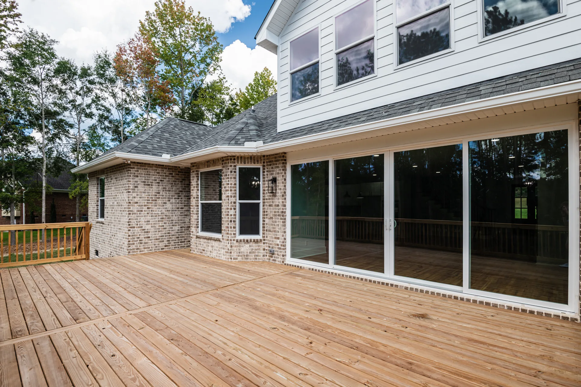 Rear elevation with deck and white upper siding
