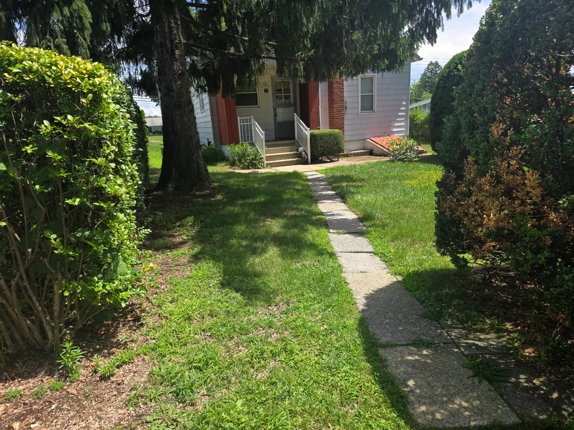 Front facade of 2838 Cherryville Rd showing classic Cape Cod architecture with mature landscaping