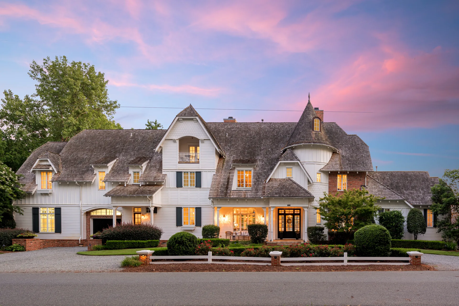 Twilight view of 17831 Mollypop Lane showing the traditional European-inspired facade with warm interior lighting