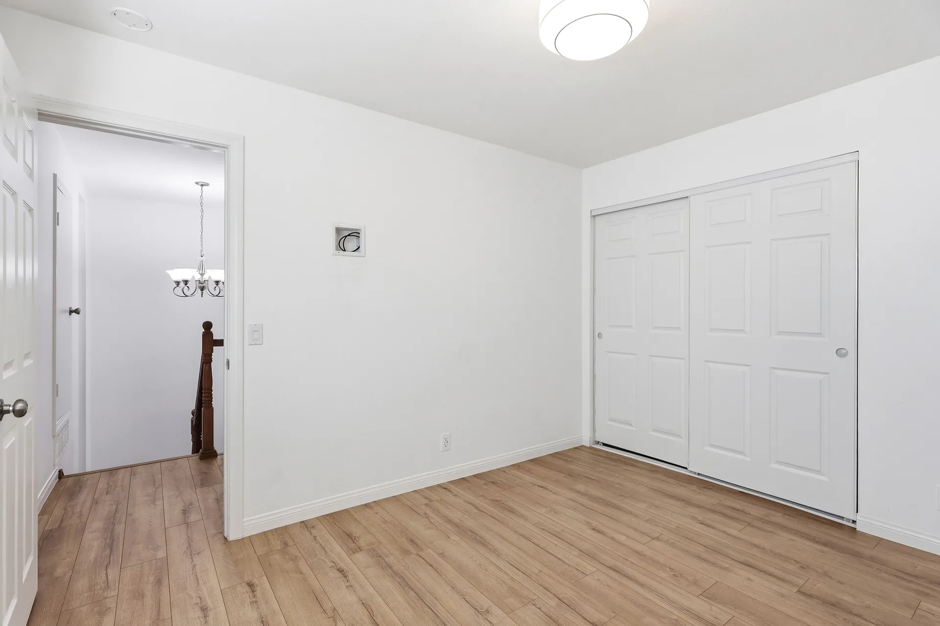 Bright bedroom at 8 Silverwood with white walls and newly installed wood-look flooring