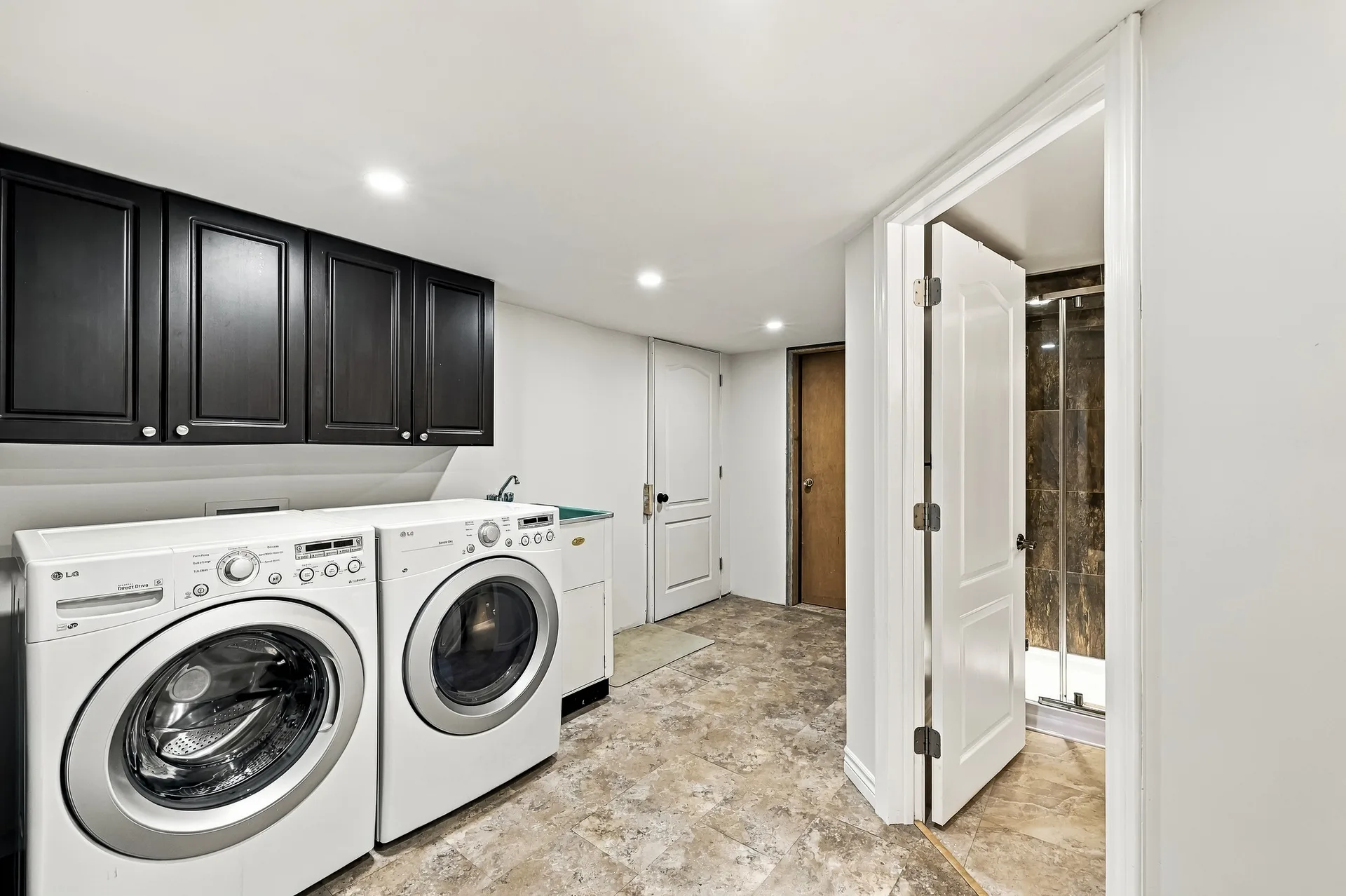 Combined laundry and bathroom space with washer, dryer and shower