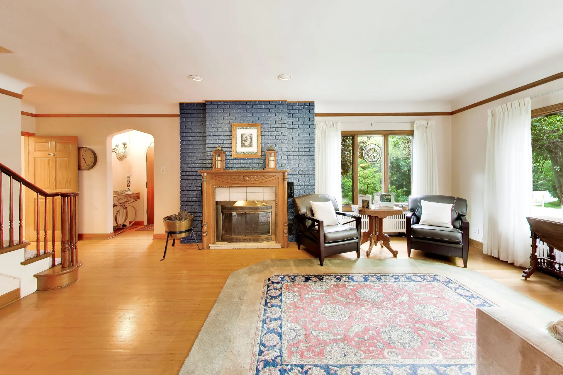 Living room with navy-painted brick fireplace