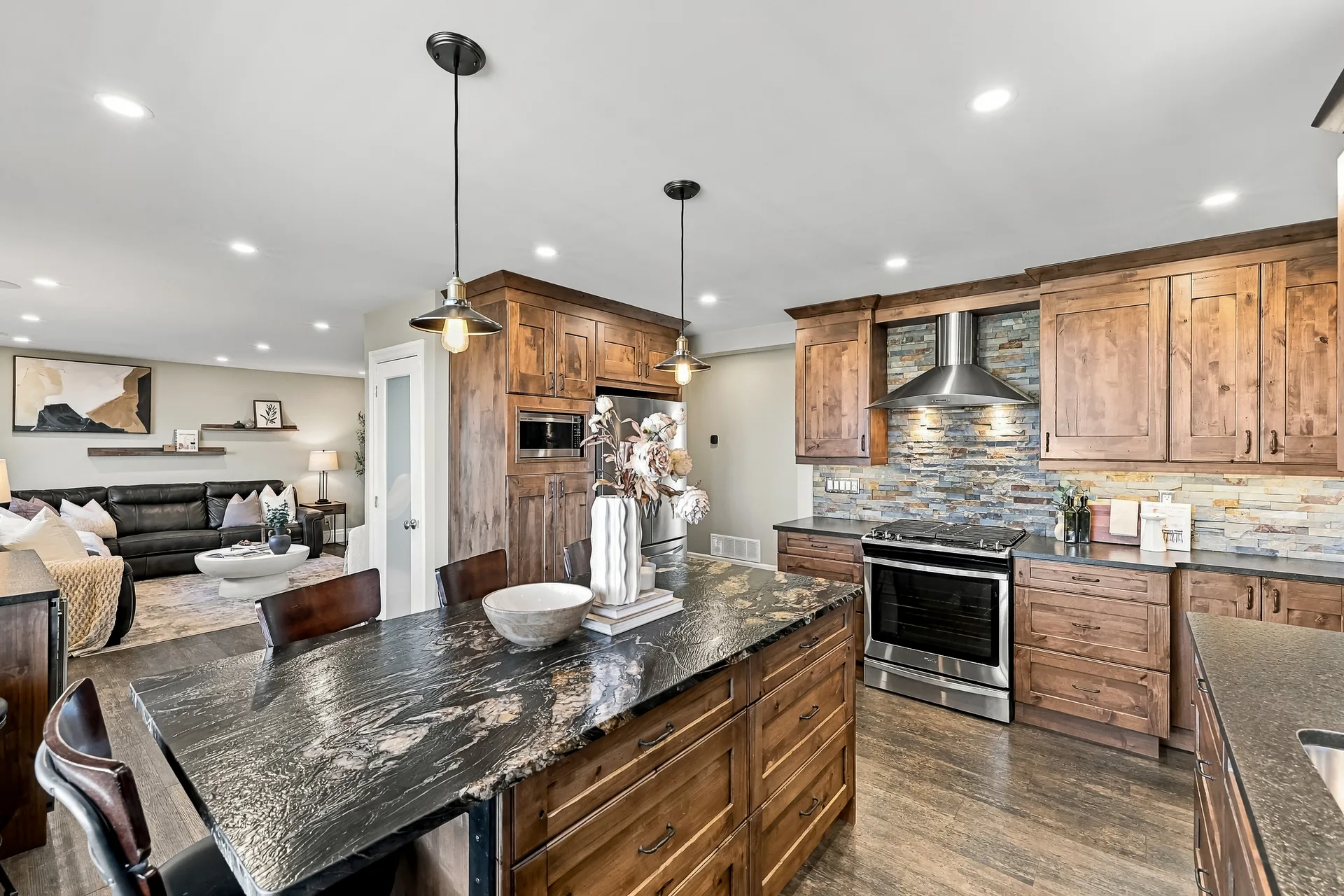 Open-concept kitchen and living room with island seating for four to six